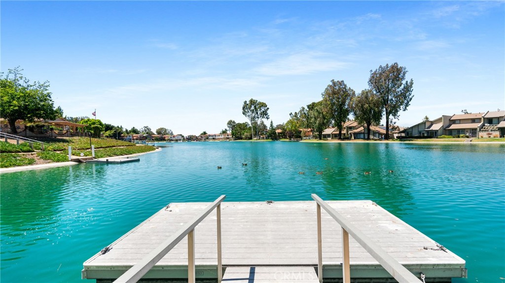 1598 Border Avenue, Unit H Corona, CA 92882 - Photo 30 of 37 a wooden bench sitting next to a lake view
