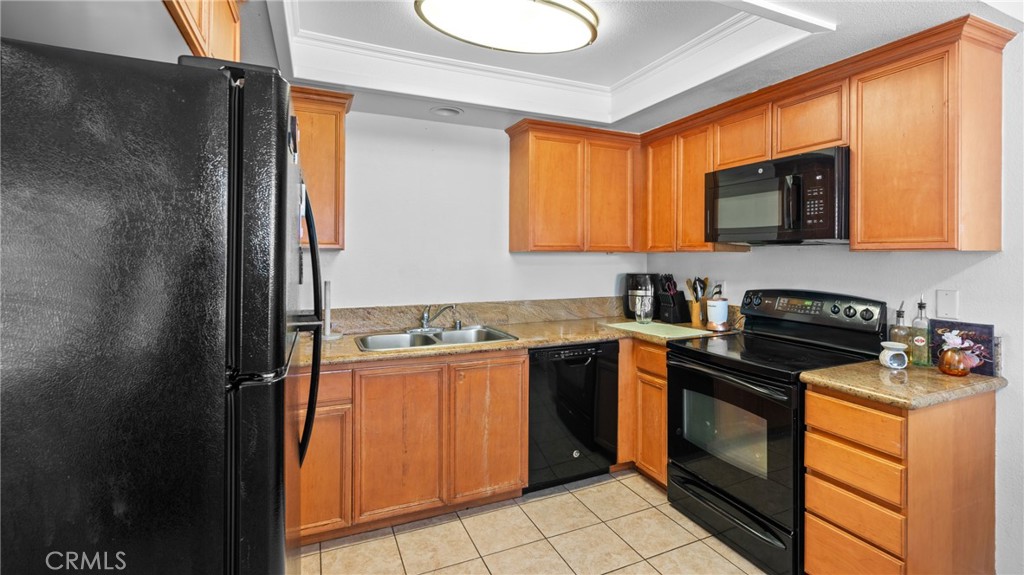 1598 Border Avenue, Unit H Corona, CA 92882 - Photo 8 of 37 a kitchen with stainless steel appliances granite countertop a stove a sink and a refrigerator