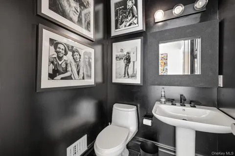 a bathroom with a toilet sink and mirror