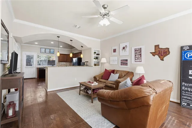 a living room with furniture and kitchen view
