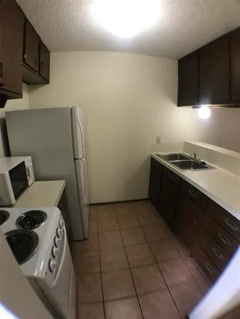 a kitchen with a stove and a refrigerator