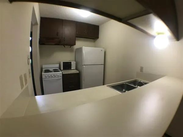 a kitchen with a refrigerator sink and microwave