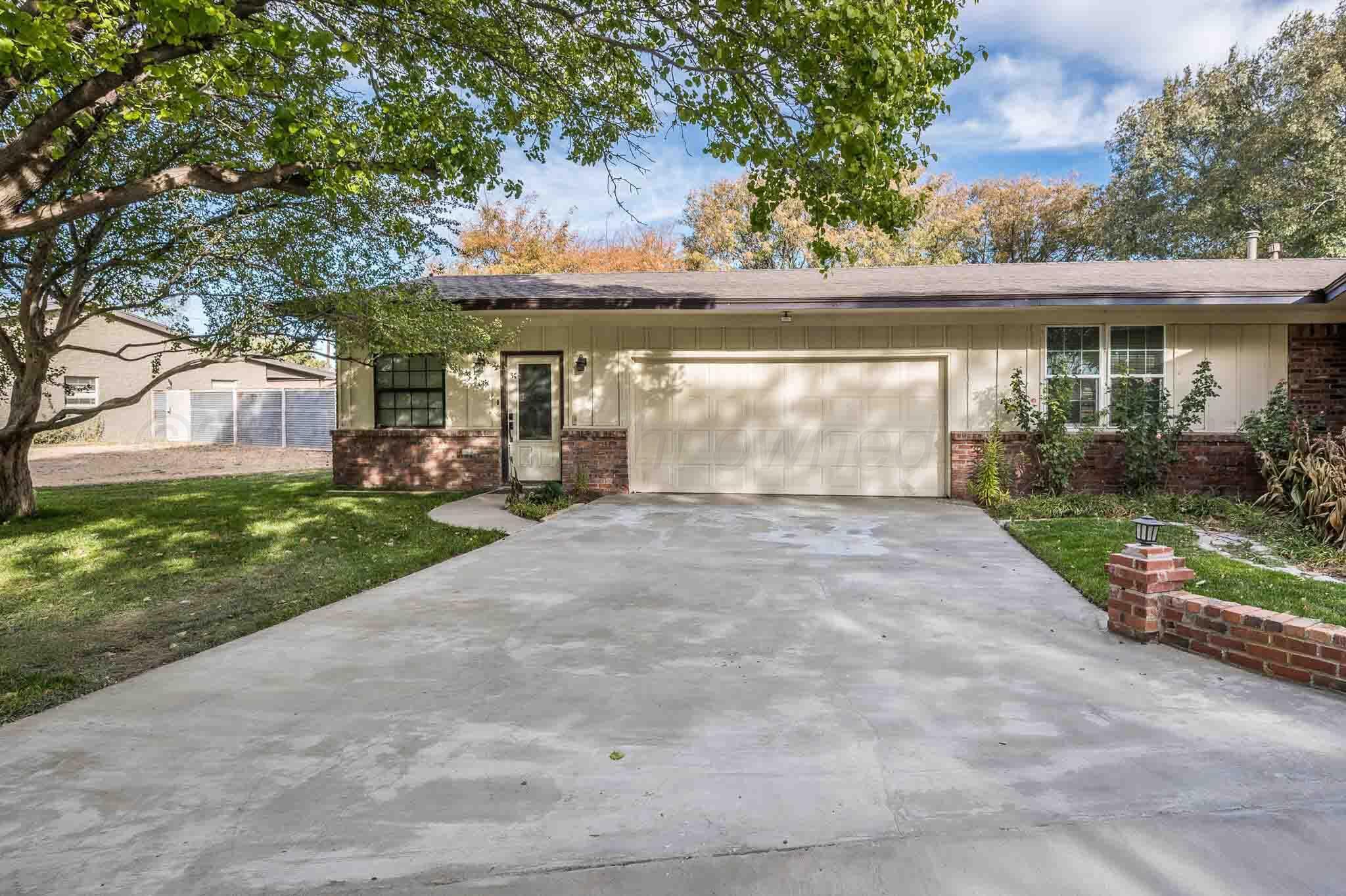 4220 Arden Road Amarillo, TX 79110 - Photo 3 of 36 front view of house with a yard and potted plants