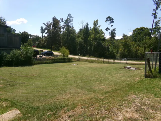 a view of a swimming pool with a yard and a sitting area