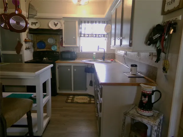 a kitchen with a sink appliances and cabinets