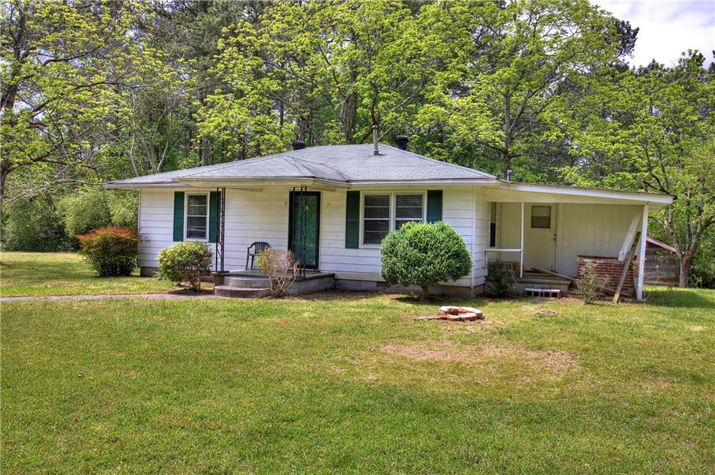 8239 Tyree Road Winston, GA 30187 - Photo 1 of 1 a view of a house with backyard sitting area and garden
