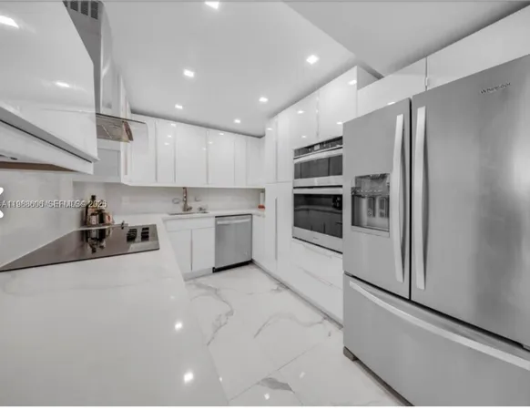 a kitchen with stainless steel appliances a refrigerator sink and microwave