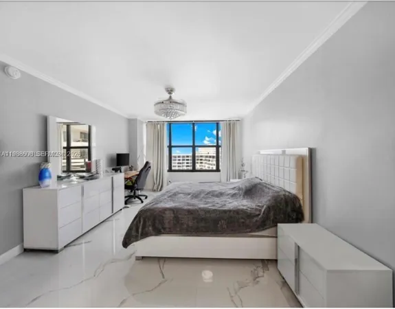 a spacious bedroom with a bed and window