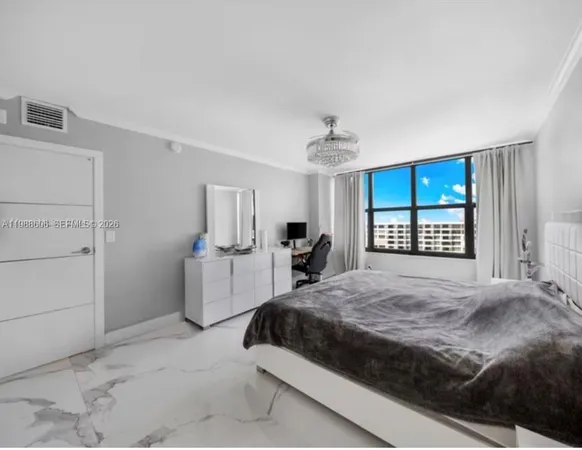 a bedroom with a large bed and a window