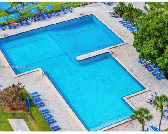 a view of a lake with a table and chairs
