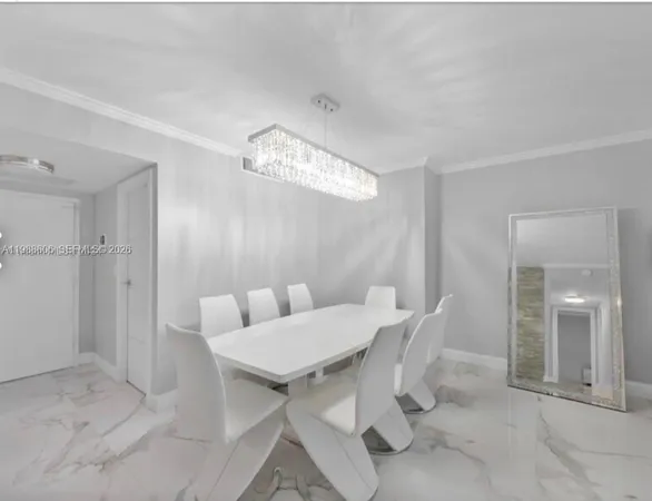 a view of a dining room with furniture and chandelier