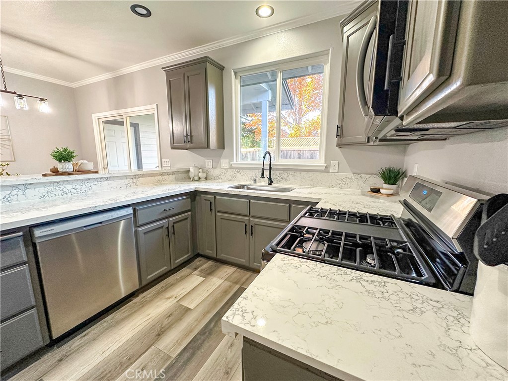 16 Tierra Rosa Lane Chico, CA 95973 - Photo 12 of 43 a kitchen with a sink a stove cabinets and a wooden floor