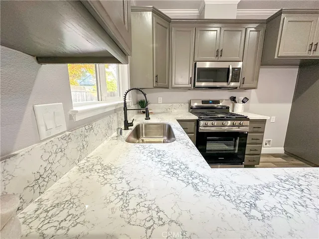 a bathroom with a granite countertop sink a toilet and a mirror