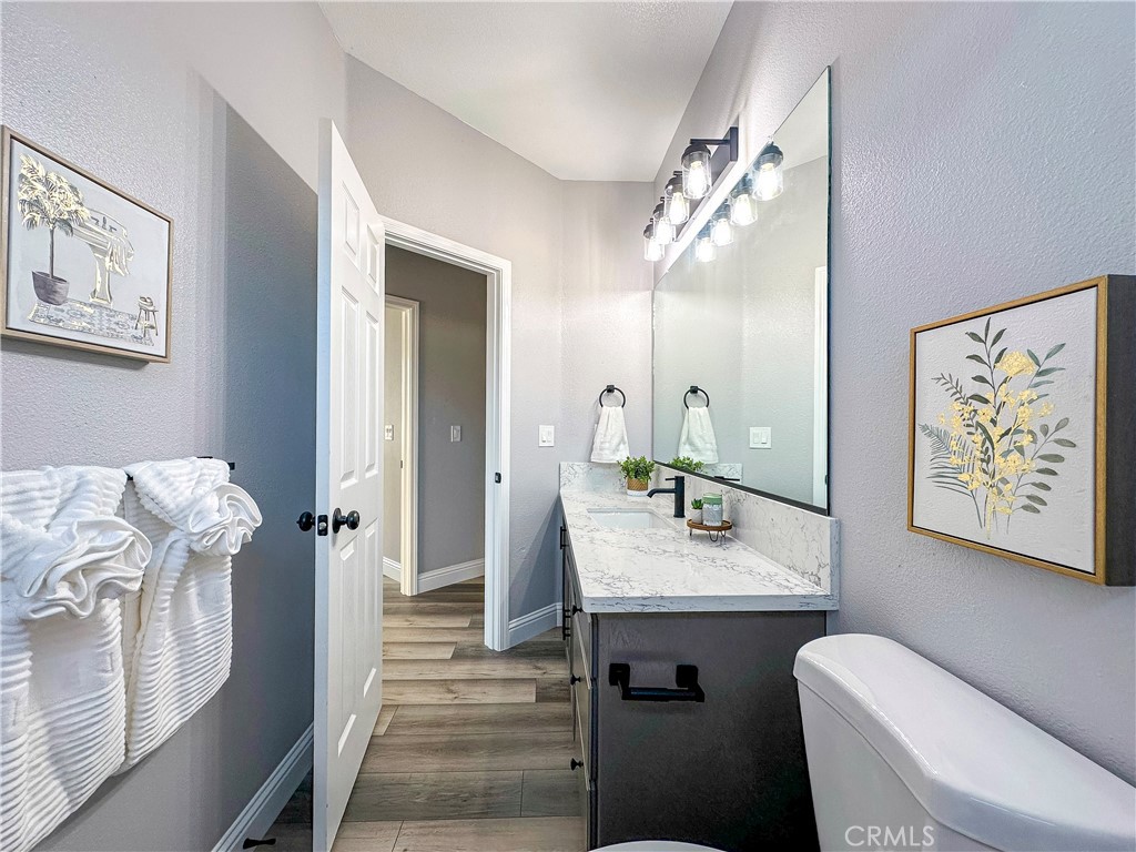 16 Tierra Rosa Lane Chico, CA 95973 - Photo 21 of 43 a bathroom with a granite countertop sink a toilet a mirror and shower