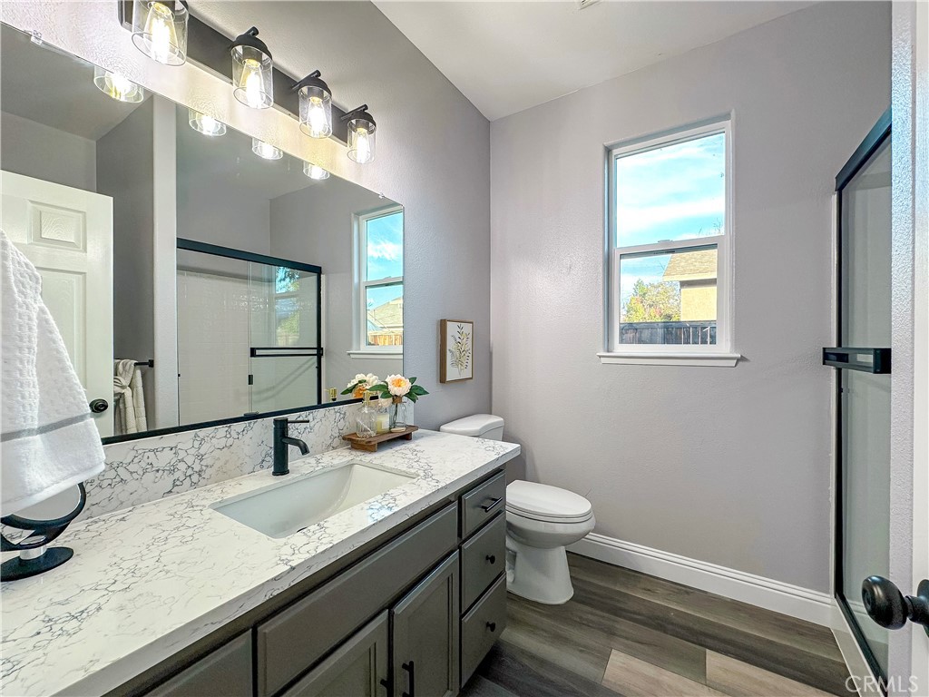 16 Tierra Rosa Lane Chico, CA 95973 - Photo 31 of 43 a bathroom with a granite countertop sink a toilet and a mirror
