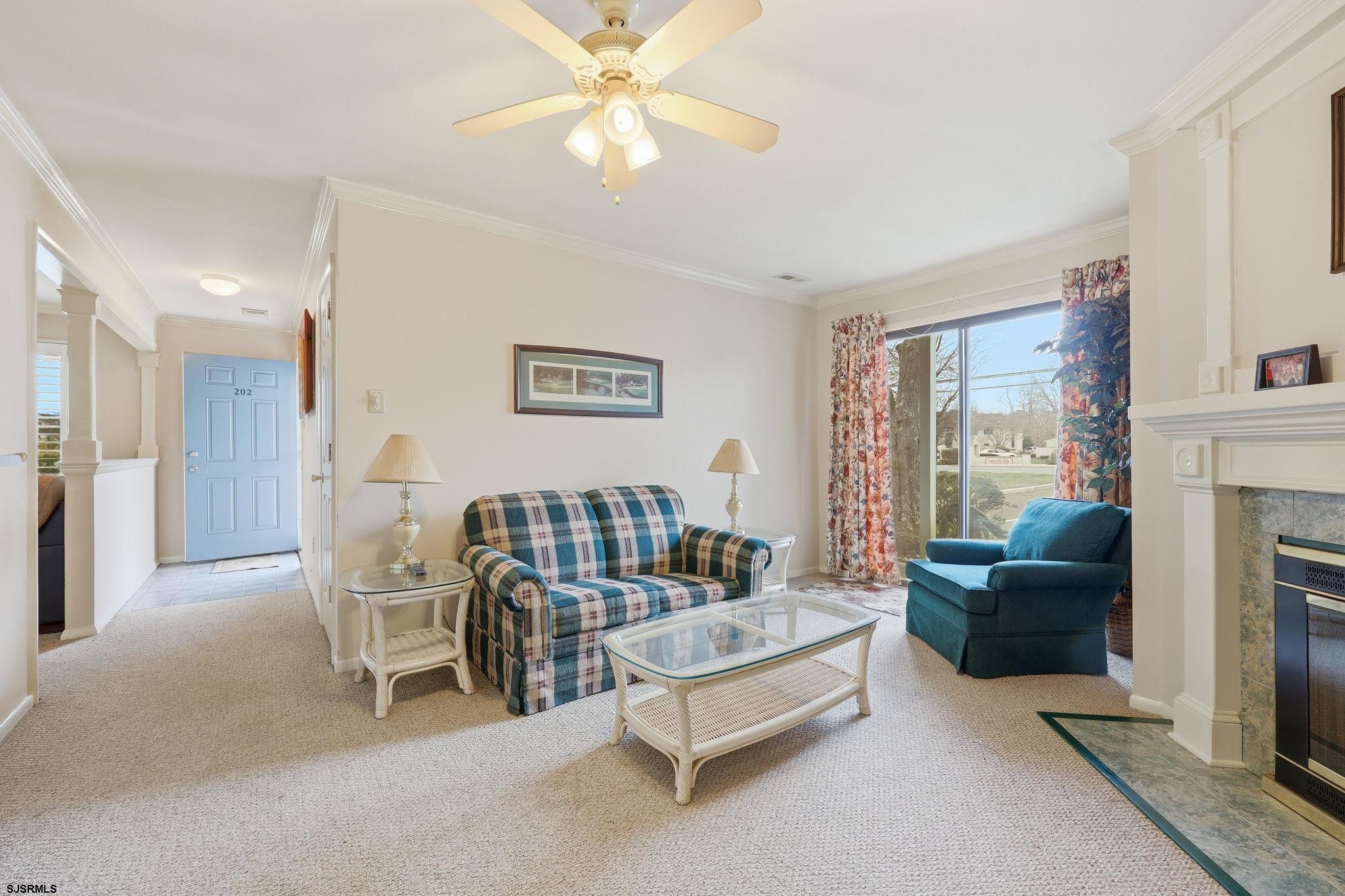 598 Mays Landing Road, Unit 202 Somers Point, NJ 08244 - Photo 11 of 23 a living room with furniture and a fireplace