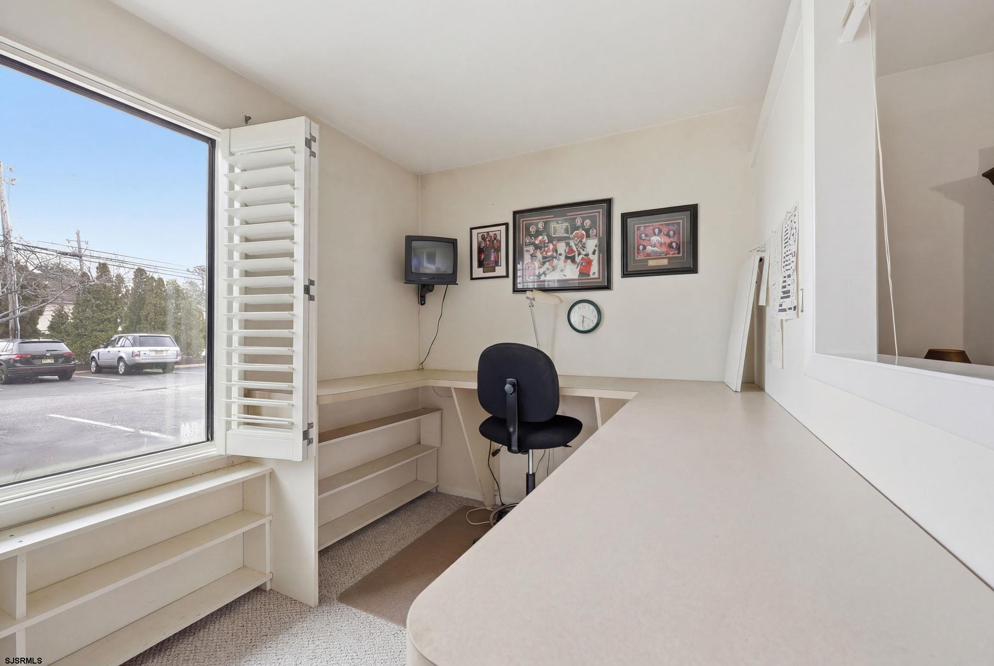 598 Mays Landing Road, Unit 202 Somers Point, NJ 08244 - Photo 14 of 23 a bedroom with a bed and a large window with the outer view
