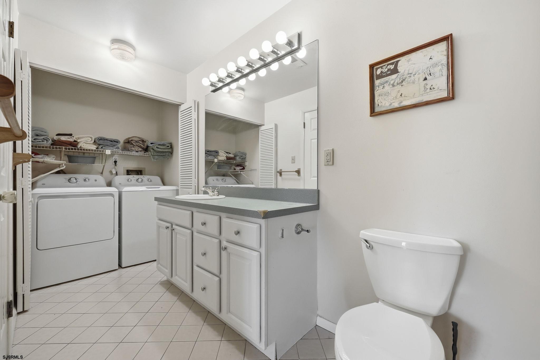 598 Mays Landing Road, Unit 202 Somers Point, NJ 08244 - Photo 15 of 23 a bathroom with a toilet sink and mirror