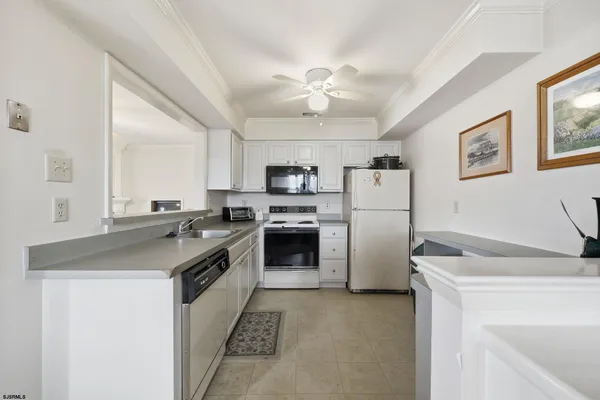 a kitchen with a sink stove and refrigerator