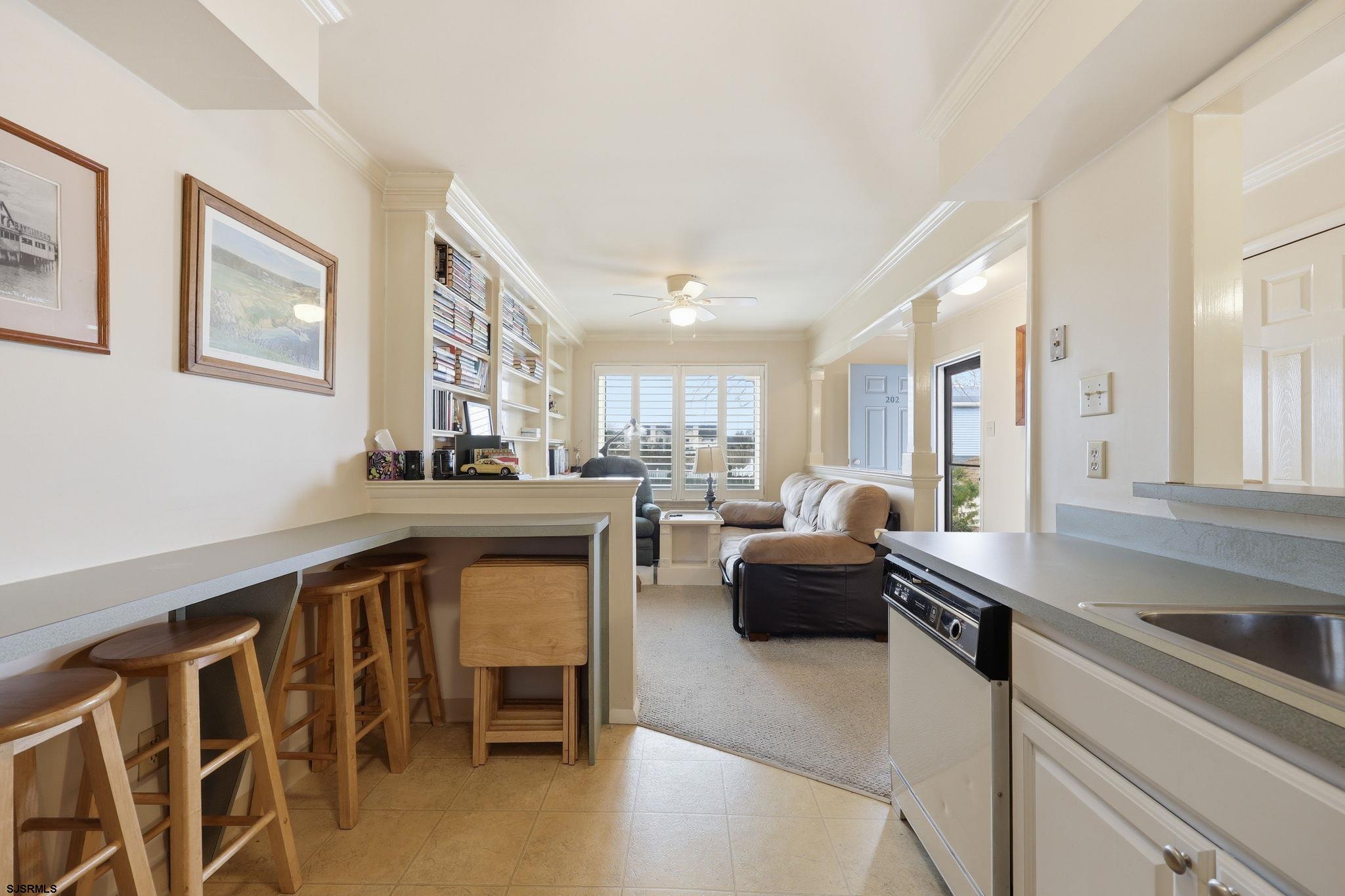 598 Mays Landing Road, Unit 202 Somers Point, NJ 08244 - Photo 8 of 23 a living room with furniture a large window and kitchen view