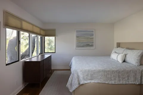 a bedroom with a large bed and a large window