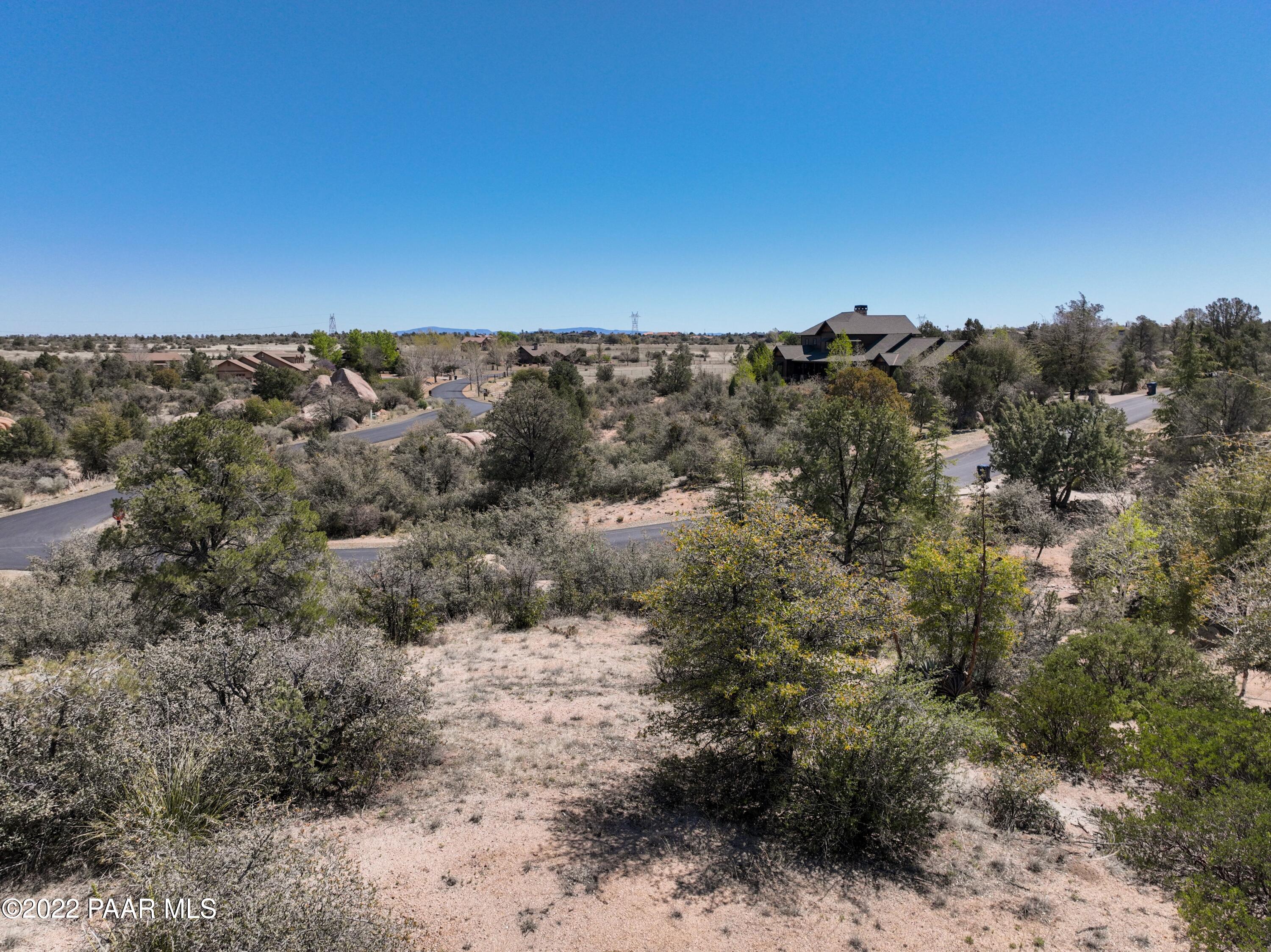 9970 Clear Fork Road Prescott, AZ 86305 - Photo 20 of 23 a view of a dry yard with mountains in the background