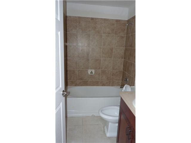 4525 Mathis Street Lake Worth, FL 33461 - Photo 7 of 8 a bathroom with a bathtub and toilet