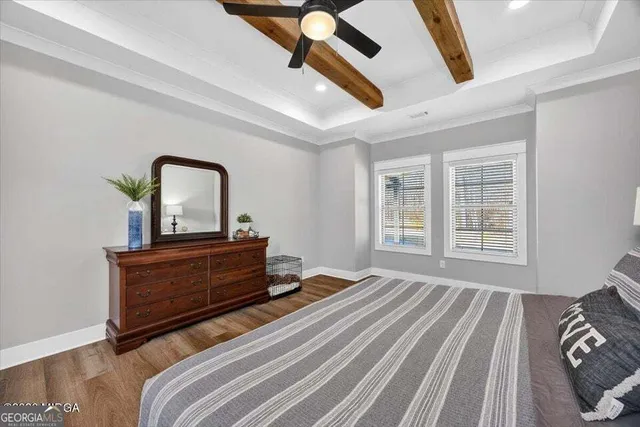 a bed sitting in a bedroom next to a window