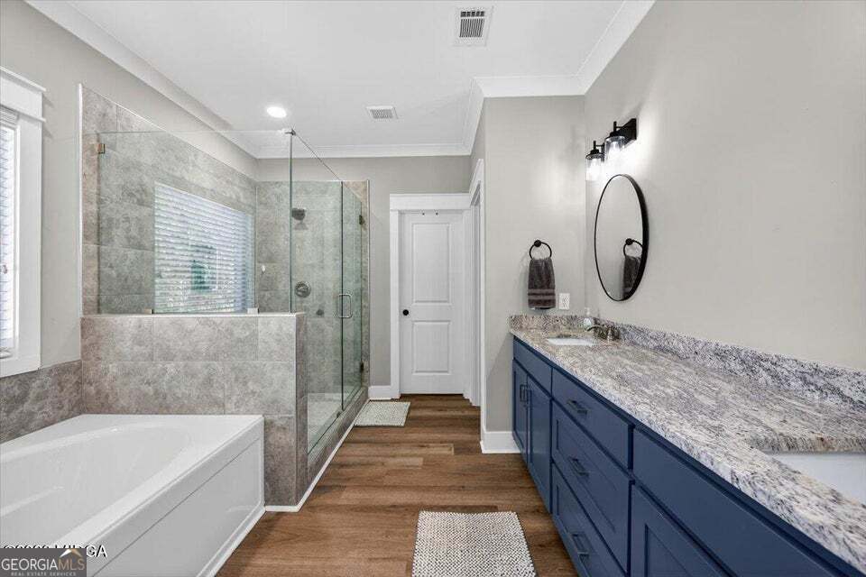 303 Tuxedo Circle Forsyth, GA 31029 - Photo 18 of 45 a bathroom with a granite countertop tub a double vanity sink and a mirror