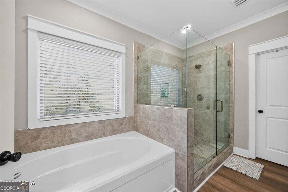 303 Tuxedo Circle Forsyth, GA 31029 - Photo 19 of 45 a bathroom with a bathtub and shower
