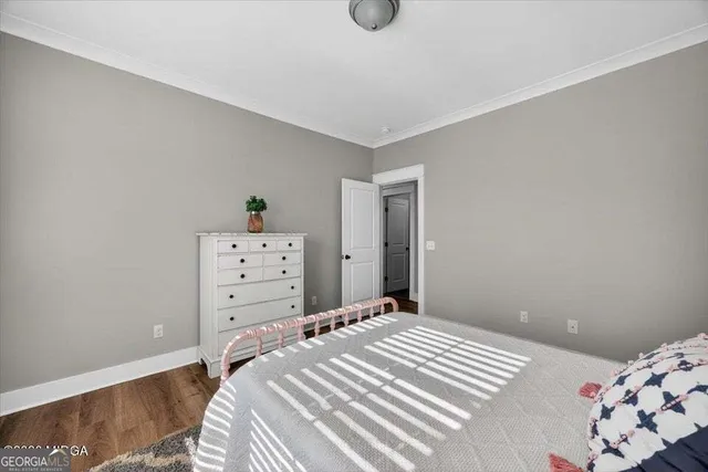 a bedroom with a bed and dresser