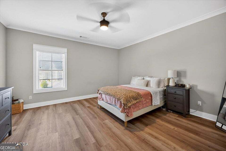 303 Tuxedo Circle Forsyth, GA 31029 - Photo 23 of 45 a bedroom with a bed and wooden floor
