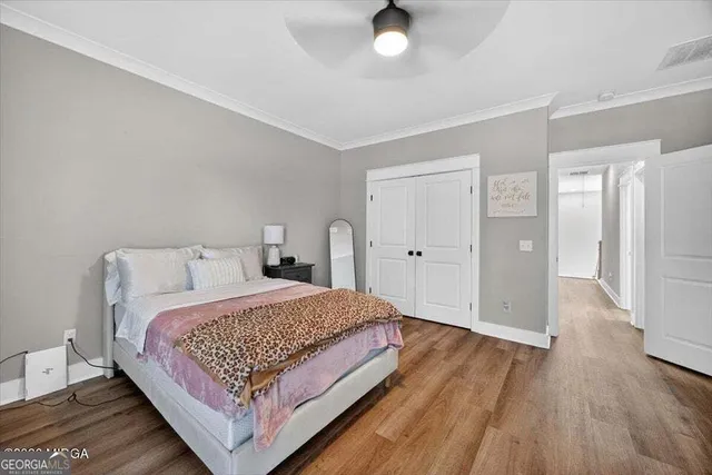 a bedroom with a bed and wooden floor