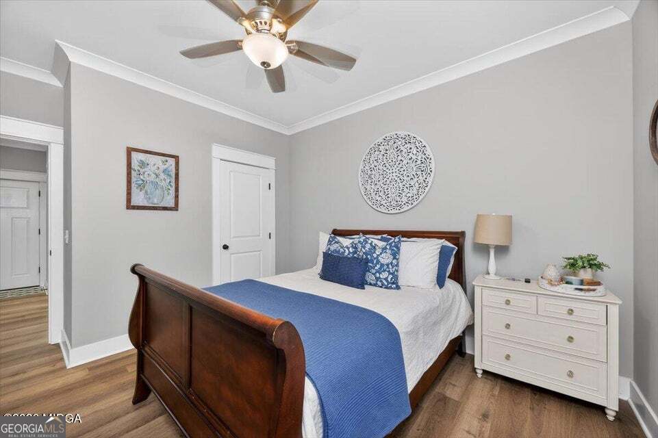 303 Tuxedo Circle Forsyth, GA 31029 - Photo 25 of 45 a bedroom with a bed and a chandelier