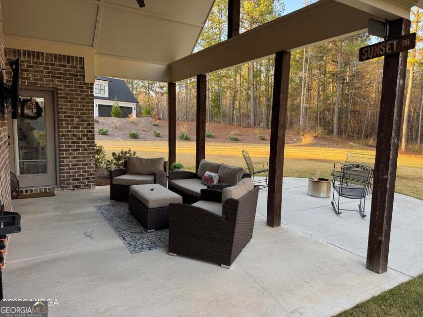303 Tuxedo Circle Forsyth, GA 31029 - Photo 29 of 45 a living room with furniture and floor to ceiling windows