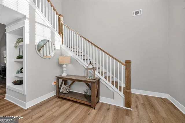 a view of entryway with wooden floor and stairs