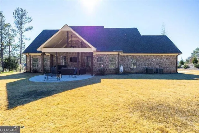 a view of a house with a yard patio and swimming pool
