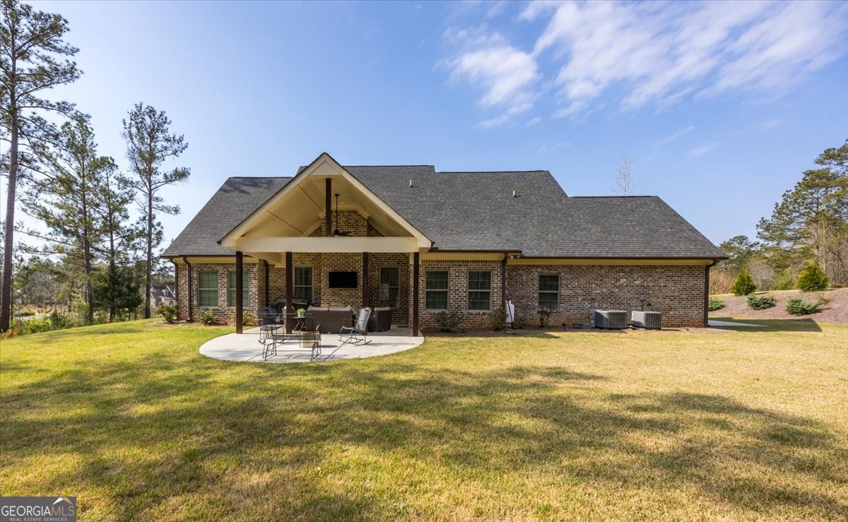 303 Tuxedo Circle Forsyth, GA 31029 - Photo 32 of 45 a front view of house with yard and trees in the background