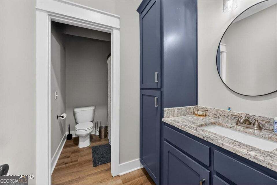 303 Tuxedo Circle Forsyth, GA 31029 - Photo 37 of 45 a bathroom with a granite countertop sink toilet and mirror
