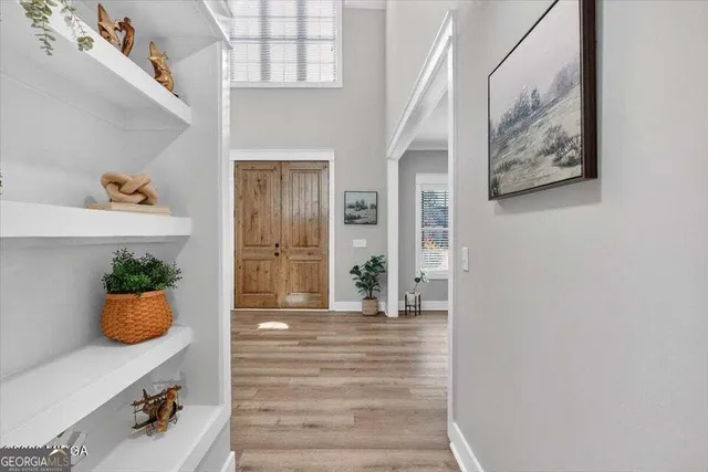 a view of an entryway with wooden floor