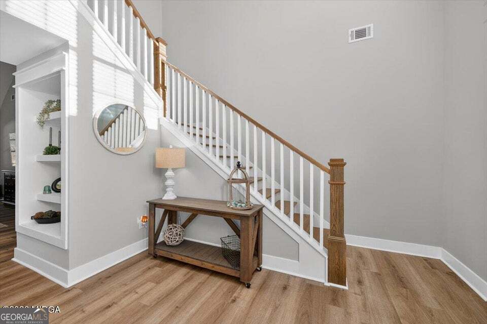 303 Tuxedo Circle Forsyth, GA 31029 - Photo 5 of 45 a view of entryway with wooden floor and stairs