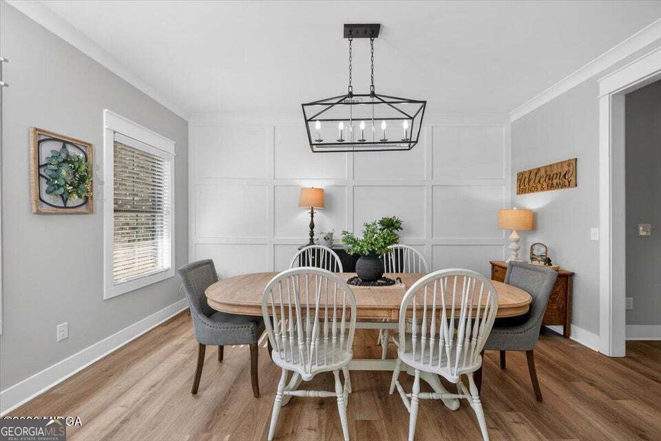 303 Tuxedo Circle Forsyth, GA 31029 - Photo 8 of 45 a view of a dining room with furniture window and wooden floor