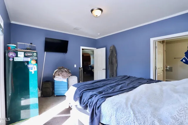 a bedroom with a bed and a tv