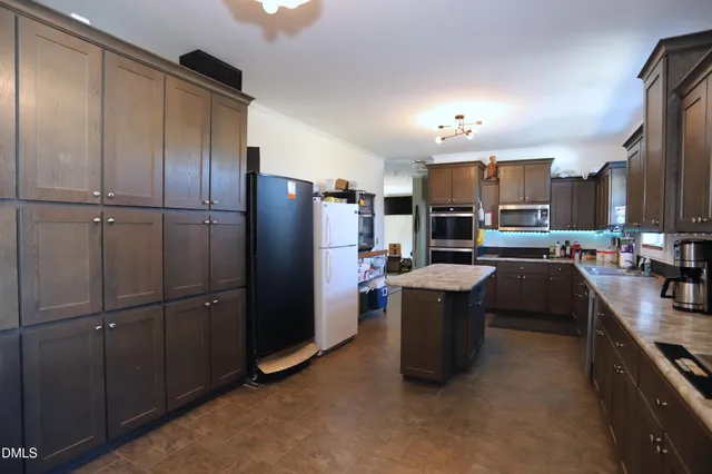 a kitchen with refrigerator and cabinets