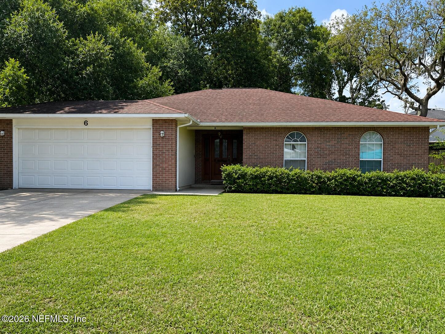 a front view of house with yard and trees