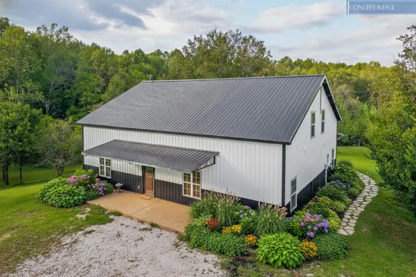 a aerial view of a house with a yard and potted plants