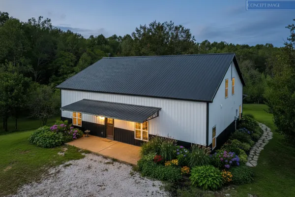 a aerial view of a house with a yard and a sitting area