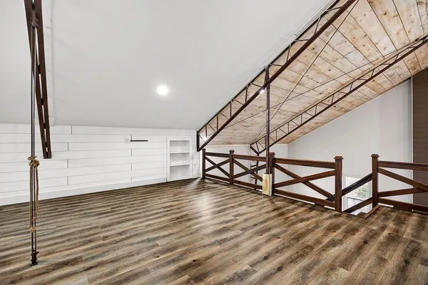 a view of a lush green forest with a lake and mountain view