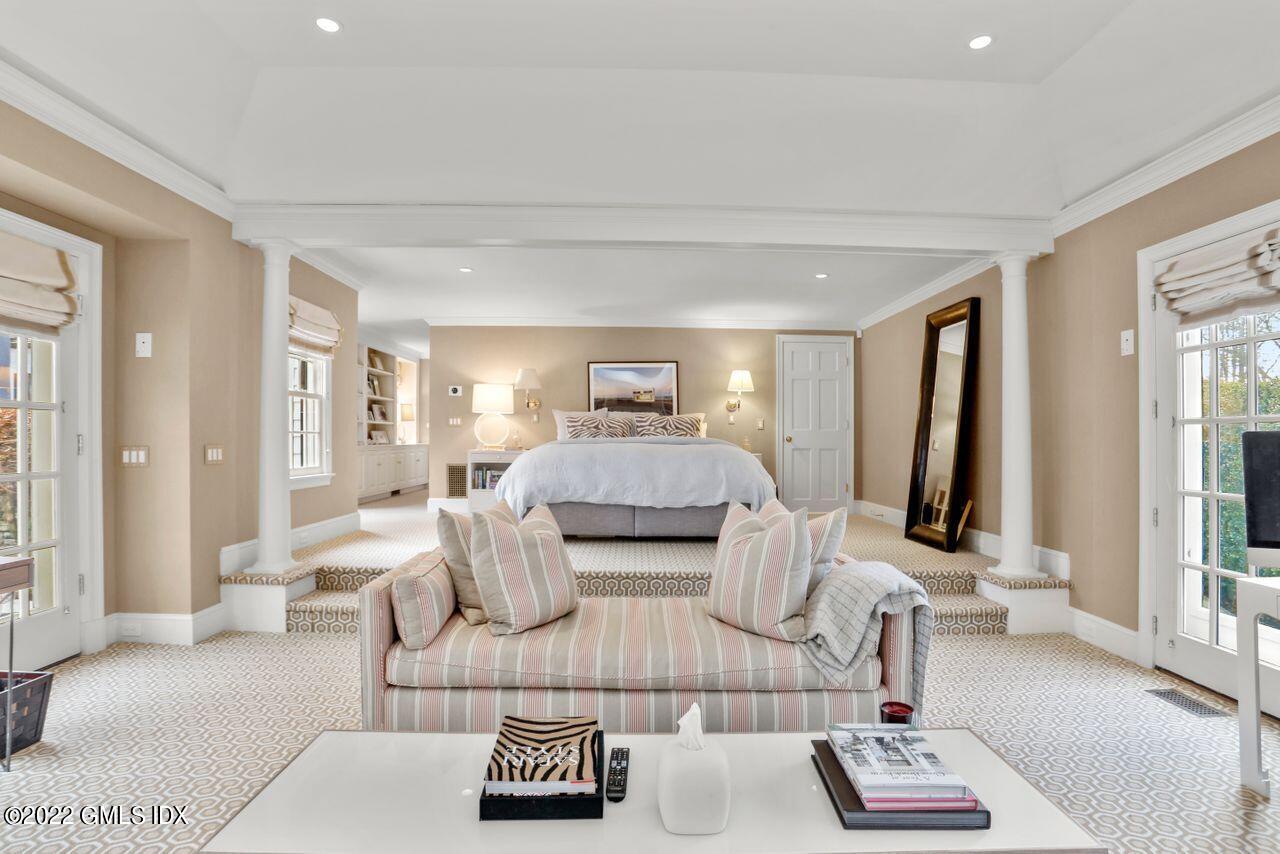 415 Round Hill Road Greenwich, CT 06831 - Photo 17 of 36 a bedroom with furniture and a large mirror