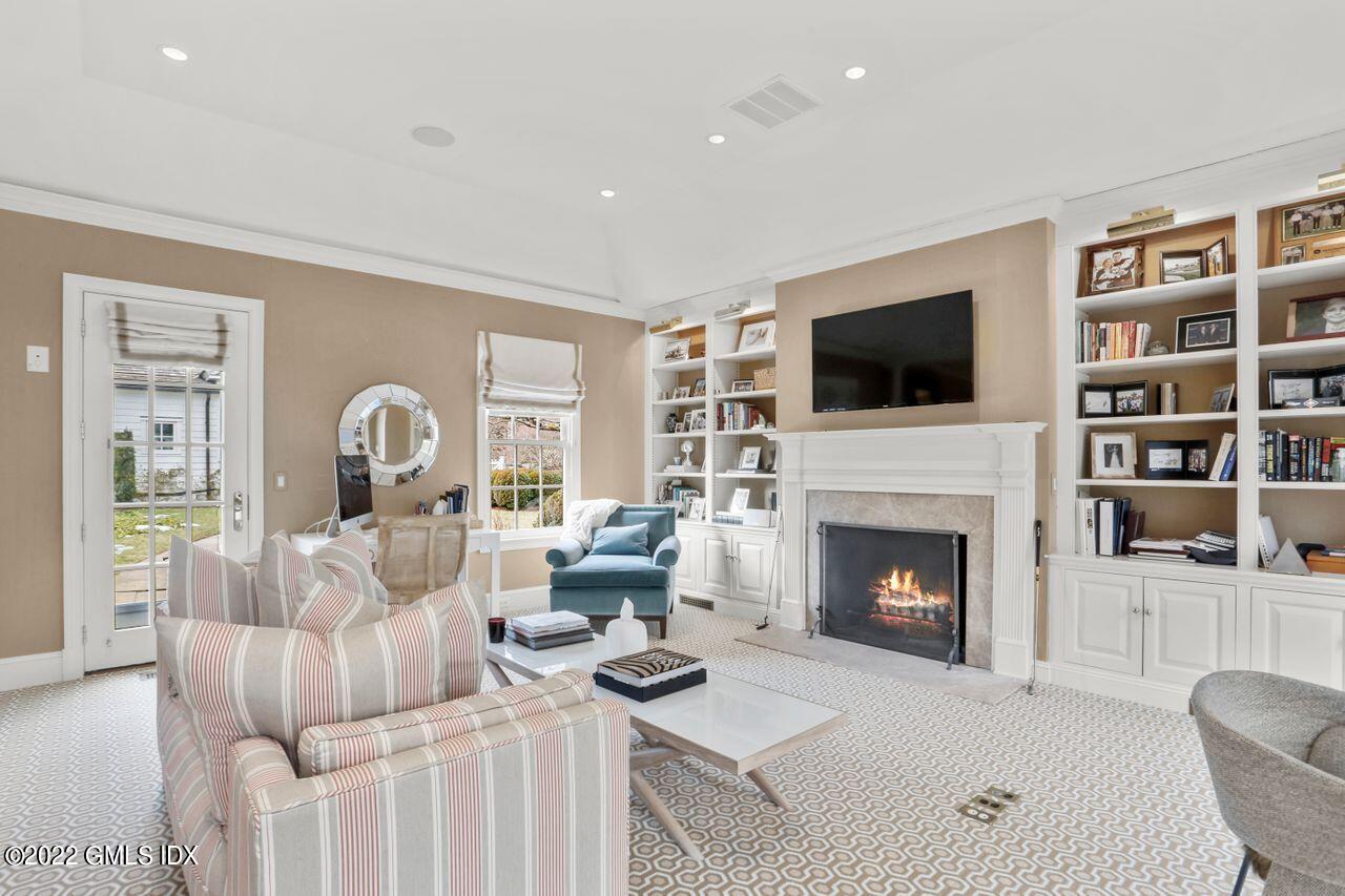 415 Round Hill Road Greenwich, CT 06831 - Photo 18 of 36 a living room with furniture fireplace and flat screen tv